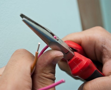 Stripping the ends of the wires with pliers