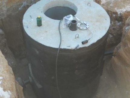 Sticker of rolled waterproofing on the walls of a concrete septic tank