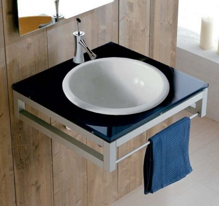 Compact round washbasin in colored countertop